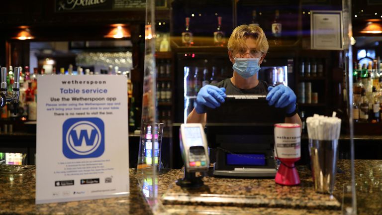 A staff member at the reopening of Wetherspoons' Toll Gate pub, in Hornsey, London