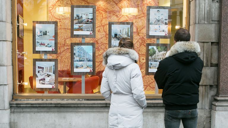 File photo dated 04/12/14 of a couple looking in the window of an estate agents.                    