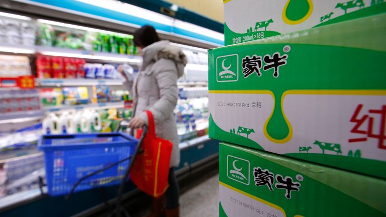 Cartons of Mengniu's milk products (R) are placed at a supermarket in Beijing February 13, 2014. 