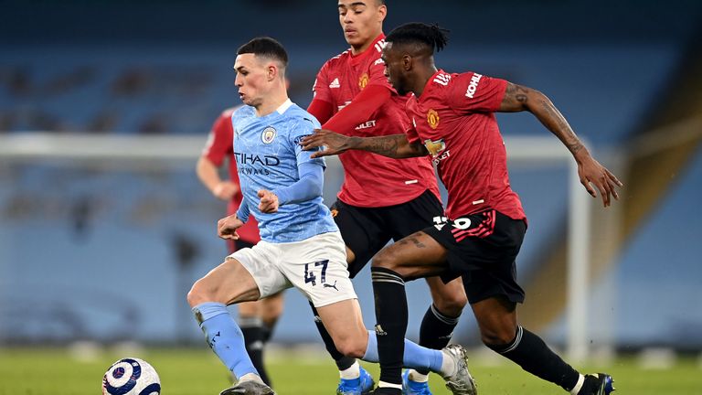 Manchester City's Phil Foden Manchester United's mason Greenwood and Aaron Wan-Bissaka (left-right) battle for the ball during the Premier League match at the Etihad Stadium, Manchester. Picture date: Sunday March 7, 2021.