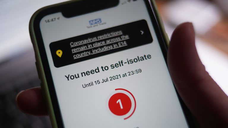 A message to self-isolate, with one day of required isolation remaining, is displayed on the NHS coronavirus contact tracing app on a mobile phone, in London. Picture date: Thursday July 15, 2021.