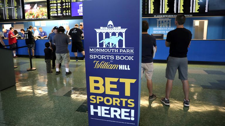 Gamblers place bets on sports at Monmouth Park Sports Book by William Hill, shortly after the opening of the first day of legal betting on sports in Oceanport, New Jersey, US