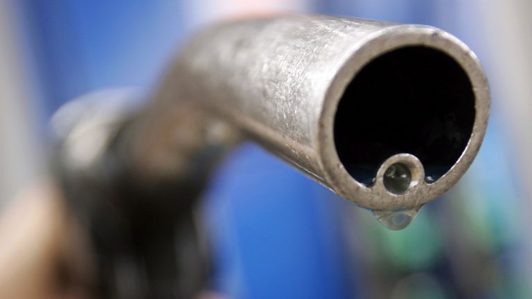 A motorist holds a fuel pump