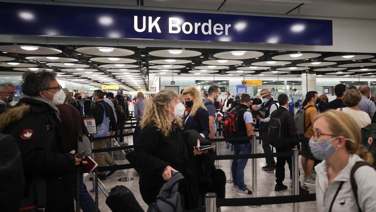 Arriving passengers queue at UK Border Control at the Terminal 5 at Heathrow Airport in London