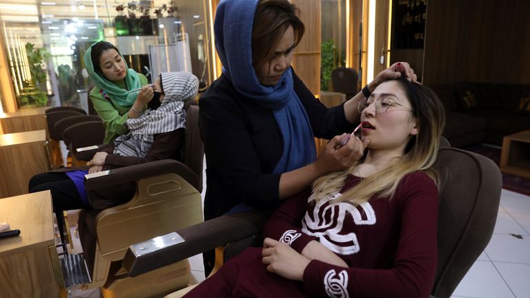 Beauticians apply makeup on customers at Ms. Sadat’s Beauty Salon in Kabul, Afghanistan, Sunday, April 25, 2021. Kabul's young working women say they fear their dreams may be short-lived if the Taliban return to Kabul, even if peacefully as part of a new government. Credit: AP