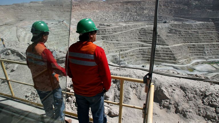 Workers at BHP Billiton's Escondida, the world's biggest copper mine, are seen in front of the open pit, in Antofagasta, northern Chile March 31, 2008