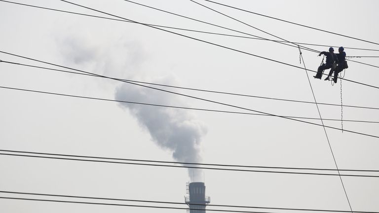 Workers work on high voltage power lines in Tongling, Anhui province, China 