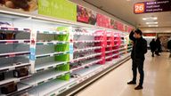 FILE PHOTO: A man stands next to shelves empty of fresh meat in a supermarket, as the number of worldwide coronavirus cases continues to grow, in London, Britain, March 15, 2020. REUTERS/Henry Nicholls//File Photo