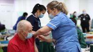 Silja Mai (right), Immunisation Nurse, gives Ron Mees, aged 69, a dose of the Oxford/Astra Zeneca Covid-19 vaccine, during a mass vaccination of members of the public at Robertson House, Stevenage. Picture date: Tuesday February 9, 2021.