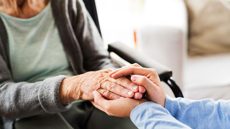 Unrecognizable health visitor and a senior woman during home visit
