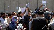 Hundreds of people gather some holding documents, near an evacuation control checkpoint on the perimeter of the Hamid Karzai International Airport, in Kabul. Pic: AP