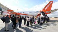 Passengers at Gatwick airport board a flight to Faro in Portugal