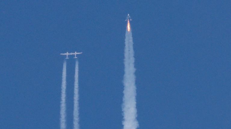 FILE PHOTO: Virgin Galactic's passenger rocket plane VSS Unity, carrying billionaire entrepreneur Richard Branson and his crew, begins its ascent to the edge of space above Spaceport America near Truth or Consequences, New Mexico, U.S., July 11, 2021. REUTERS/Joe Skipper/File Photo
