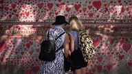 People stood next to the National Covid Memorial Wall on the Embankment in London, following the further easing of lockdown restrictions in England. Picture date: Saturday June 12, 2021.