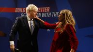 Britain's Prime Minister Boris Johnson embraces his wife Carrie Johnson after delivering a speech during the annual Conservative Party Conference, in Manchester, Britain, October 6, 2021. REUTERS/Phil Noble