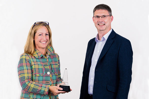 Mestag Therapeutics CEO Susan Hill received the Young Company of the Year Award from Ian Smythe of Arm.