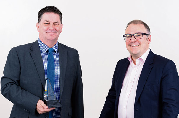  PwC’s Simon de Young (right) presents the Quoted Company of the Year trophy to Jamie Crowther, Operations Director at Marshall Motor Holdings.