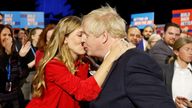 Britain's Prime Minister Boris Johnson and his wife Carrie Johnson embrace ahead of his speech during the annual Conservative Party Conference, in Manchester, Britain, October 6, 2021. REUTERS/Phil Noble
