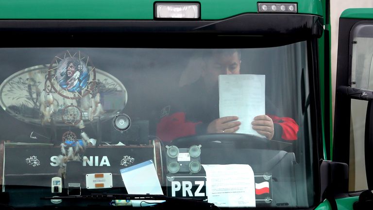 A lorry driver checks his paperwork after being processed at a customs facility in Ashford, Kent, as Channel traffic builds up following a quiet start to the year and the end of the transition period with the European Union on December 31