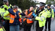 Police officers detain Insulate Britain activists blocking a motorway junction near Heathrow Airport, in London, Britain, October 1, 2021. REUTERS/Peter Cziborra
