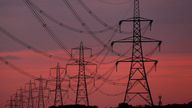 FILE PHOTO: The sun rises behind electricity pylons near Chester, northern England October 24, 2011. REUTERS/Phil Noble/File Photo
