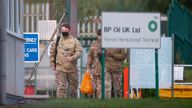 Members of the military walk at Buncefield Oil Depot in Hemel Hempstead, Britain, October 4, 2021. REUTERS/Andrew Boyers
