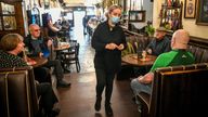 Staff serve at tables inside The Borough pub on St Mary's Street, Cardiff