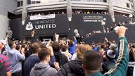 Jubilant Newcastle United fans celebrate the club's Saudi takeover outside the stadium.