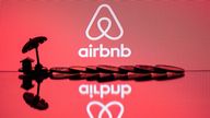 This illustration picture taken in Paris on August 29, 2018, a toy umbella and coins  next to the logo of  rental website Airbnb. (Photo by JOEL SAGET / AFP)        (Photo credit should read JOEL SAGET/AFP/Getty Images)