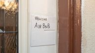 Close-up of hand drawn sign on door of a home reading Welcome AirBNB, indicating the home is made available for short term rental through the AirBNB website, Los Angeles, California, October 26, 2019. (Photo by Smith Collection/Gado/Getty Images)
