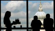 Visitors admire St Paul's Cathedral from the restaurant of the Tate Modern March 2007