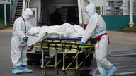 Medical specialists transport a patient outside a hospital for people infected with the coronavirus disease