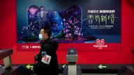 A security officer wearing a face mask walks past an advertisement for a Singles... Day shopping promotion from online shopping platform Tmall, owned by Chinese e-commerce giant Alibaba, in a subway station in Beijing, Thursday, Nov. 11, 2021. China...s biggest online shopping day, known as ...Singles... Day... on Nov. 11, is taking on a muted tone this year as regulators crack down on the technology industry and President Xi Jinping pushes for ...common prosperity.... (AP Photo/Mark Schiefelbein).