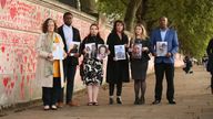 Bereaved people hold photos of loved ones lost to coronavirus (from left, with the names of those who died in brackets) Deborah Doyle (Sylvia Griffiths), Lobby Akinnola (Olufemi Akinnola), Hannah Brady (Shaun Brady/Margaret Brady), Fran Hall (Steve Mead), Jo Goodman (Stuart Goodman), Charlie Williams (Rex Williams), next to the Covid Memorial Wall on the embankment of the River Thames opposite the House of Parliament in central London. Picture date: Tuesday September 28, 2021.