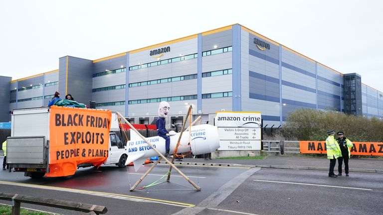 Activists from Extinction Rebellion block the entrance to the Amazon fulfilment centre in Tilbury