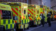 NHS workers walk next to a cue of ambulances outside the Royal London Hospital, in London, Britain January 12, 2021. REUTERS/Henry Nicholls