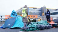 Activists from Extinction Rebellion block the entrance to the Amazon fulfilment centre in Tilbury, Essex