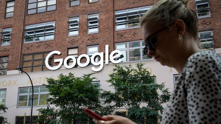 NEW YORK, NY - JUNE 3: A woman looks at her smartphone as she walks past Google Building 8510 at 85 10th Ave on June 3, 2019 in New York City. Shares of Google parent company Alphabet were down over six percent on Monday, following news reports that the U.S. Department of Justice is preparing to launch an anti-trust investigation aimed at Google. (Photo by Drew Angerer/Getty Images)
