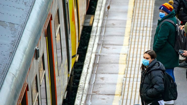 People wait on the platform at Hunts Cross Station, Liverpool, as mask wearing on public transport becomes mandatory to contain the spread of the Omicron Covid-19 variant. Picture date: Tuesday November 30, 2021.