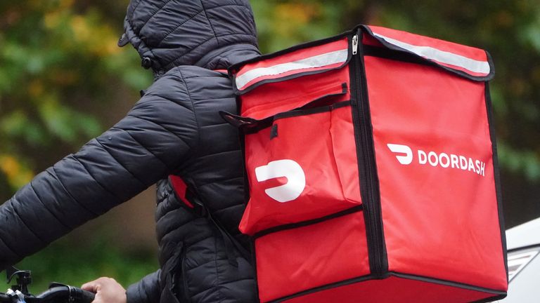 A delivery person for Doordash rides his bike in the rain in the Manhattan borough of New York City, New York, U.S., November 13, 2020