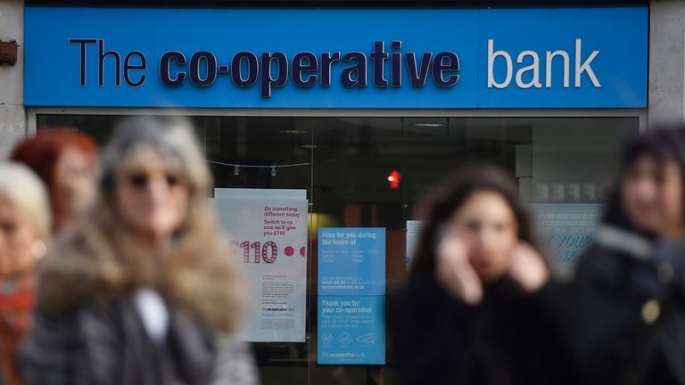 People walk past a branch of The Co-operative Bank in London