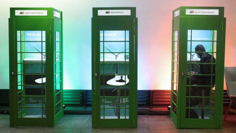 A man works in a lookalike phone box during the UN Climate Change Conference (COP 26) where world leaders discuss how to tackle climate change on a global scale in Glasgow Scotland, Britain October 31, 2021. REUTERS/Yves Herman