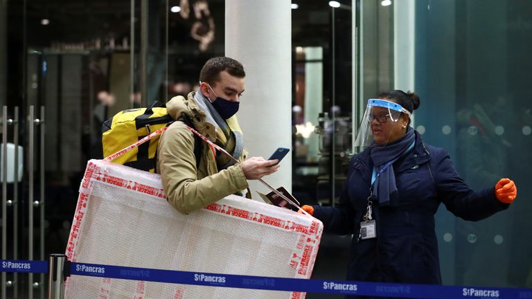 A passenger has his documents checked at the Eurostar terminal at St Pancras International, amidst the spread of the coronavirus disease (COVID-19) pandemic, in London, Britain, December 23, 2020. REUTERS/Hannah McKay