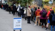 People queue to receive COVID-19 vaccine and booster doses, as the spread of the coronavirus disease (COVID-19) continues, at a walk-in vaccination centre at Saint Thomas' Hospital in London, Britain, December 14, 2021. REUTERS/Toby Melville
