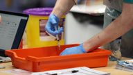 A vaccinator prepares vaccines at a COVID-19 booster vaccination centre at the Titanic Exhibition Centre in Belfast