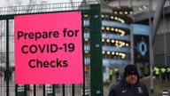 Soccer Football - Premier League - Manchester City v Leicester City - Etihad Stadium, Manchester, Britain - December 26, 2021 Fans get their coronavirus disease (COVID-19) passes checked outside the stadium before the match Action Images via Reuters/Carl Recine