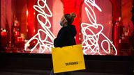 A woman walks past Selfridges on London's Oxford Street. Pic: AP