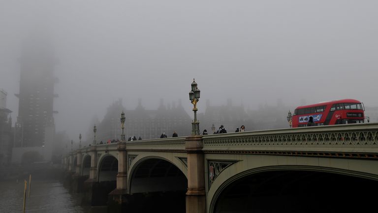 A bus crosses Westminster Bridge towards the Big Ben clocktower and the Houses of Parliament on a foggy morning in London, Britain, November 27, 2018. REUTERS/Toby Melville
