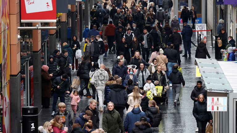 People walk along a busy shopping street as people look for bargains in the traditional Boxing Day sales in Liverpool, Britain, December 26 , 2021. REUTERS/Phil Noble
