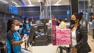 A staff member and customer at the till point, inside Primark in Oxford Street, London as a scheme enabling people to get cash from retailers' tills without needing to make a purchase is to be rolled out to more than 2,000 shops before the end of the year. 1/12/21